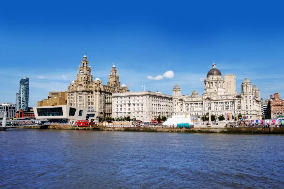The historic waterfront of Liverpool looms above the water.